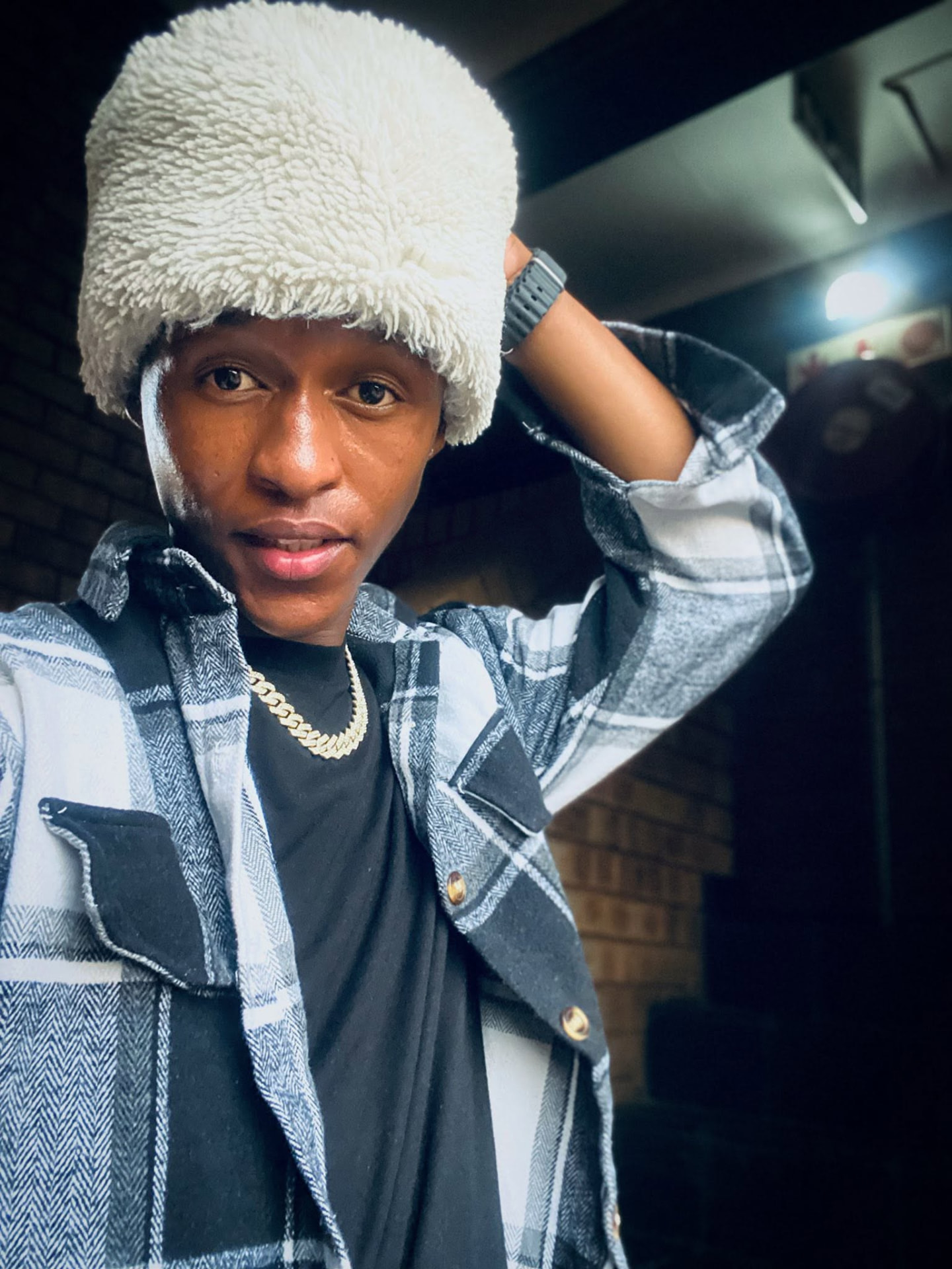 Sqiniseko SqinQ in a cream fur hat and denim jacket