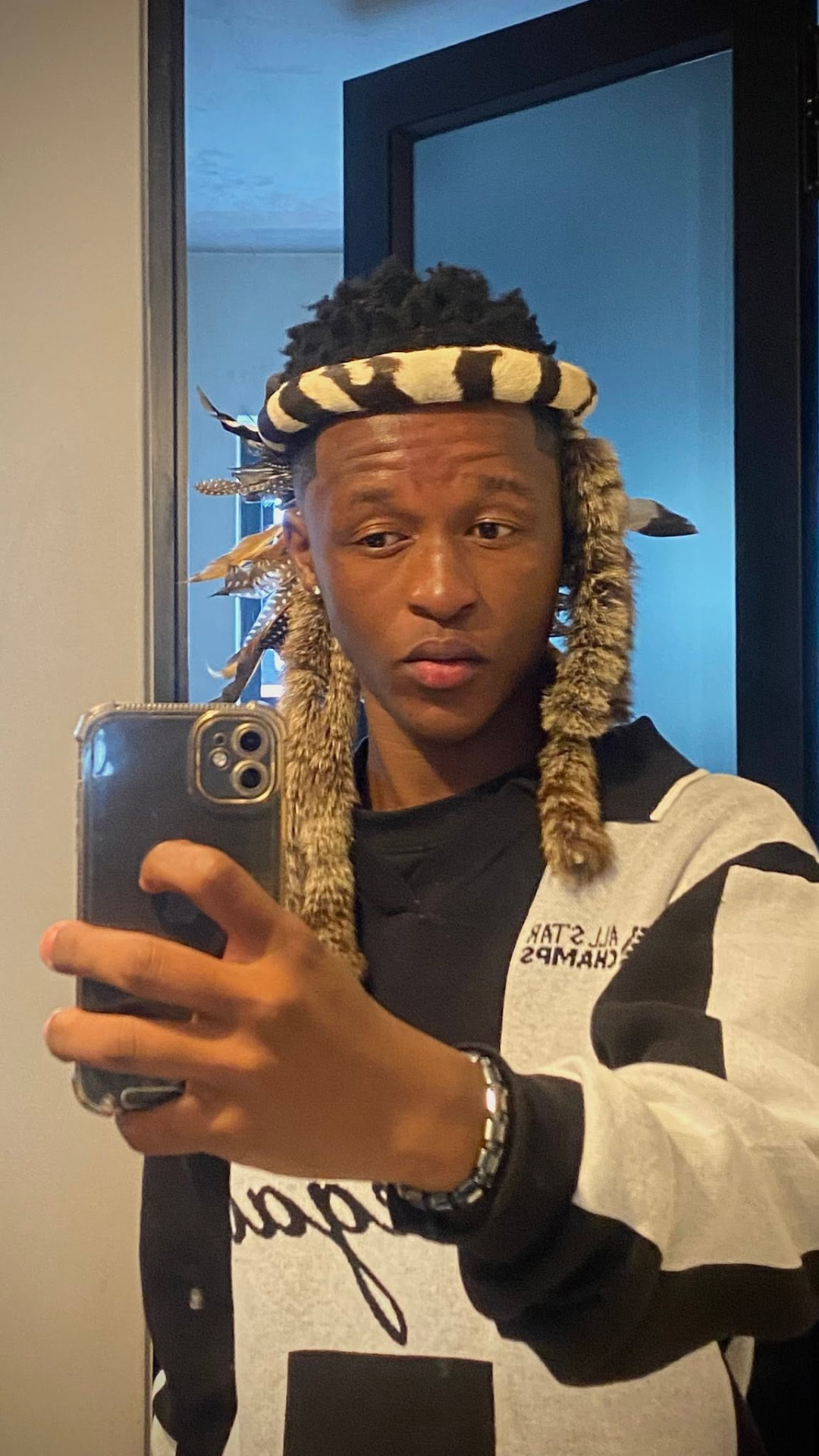 Sqiniseko SqinQ wearing a gold beaded headpiece